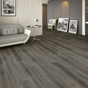 Nebraska wild oak plank flooring in modern living room with grey sofa and framed artwork