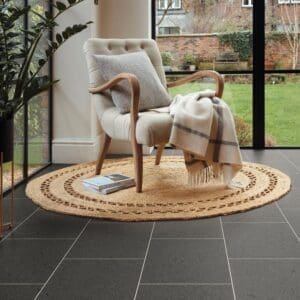 Procida limestone flooring in sunroom with natural light and comfortable seating