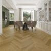 Alva natural oak parquet flooring installed in a modern dining room with green kitchen cabinets