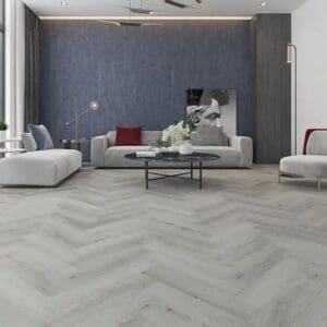 Havana grey oak parquet flooring in modern living room with grey sofa and blue wall