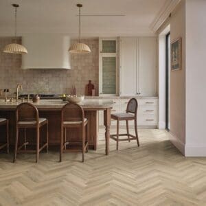 Sorrento oak herringbone flooring installed in modern kitchen with wooden island