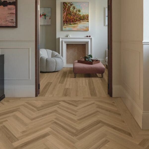 Belluno ash herringbone flooring in living room with complementary plank flooring in adjacent room