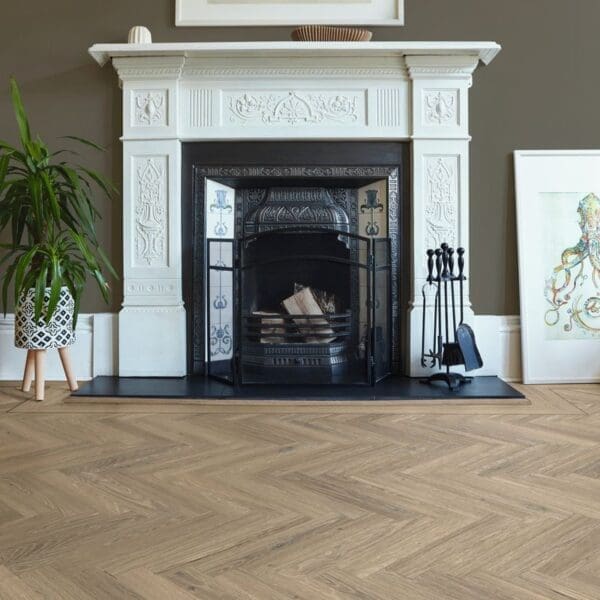 Detail of ravenna oak herringbone flooring around ornate fireplace