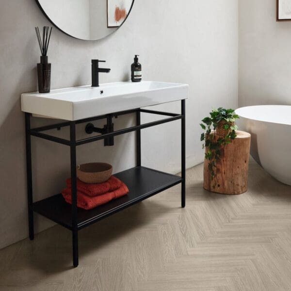 Bathroom vanity with verona prime herringbone flooring and black fixtures