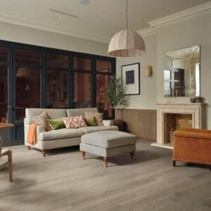 Elba oak pvp410 flooring installed in modern living room with grey sofa