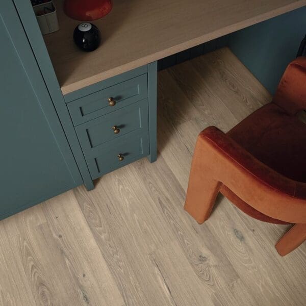 Close up of ravenna oak flooring with teal cabinetry and orange chair