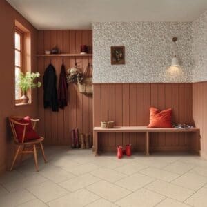 Ischia limestone pvt703 installed in entryway with terracotta walls and wooden bench