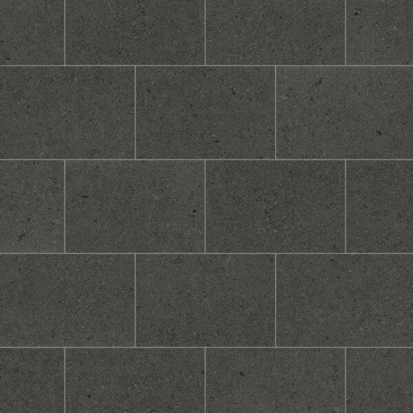 Procida limestone luxury vinyl tiles in dark charcoal with subtle aggregate pattern