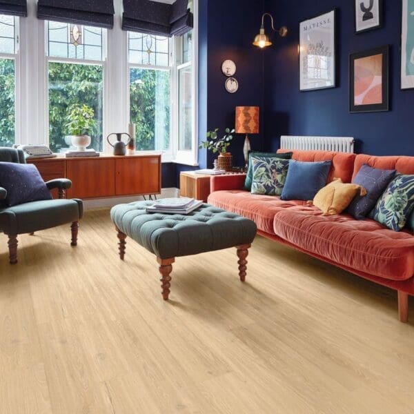 Piazza oak flooring in colorful living room with navy walls and coral sofa