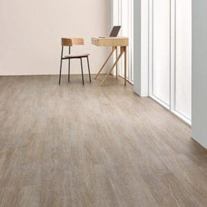 Forbo allura flex steamed oak flooring in minimalist room with wooden desk and large windows