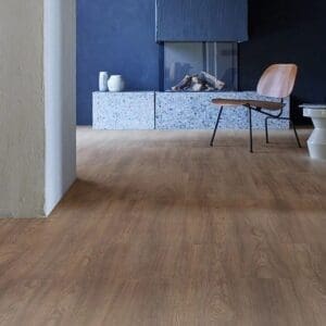 Forbo allura flex dark serene oak installed in modern living room with blue feature wall