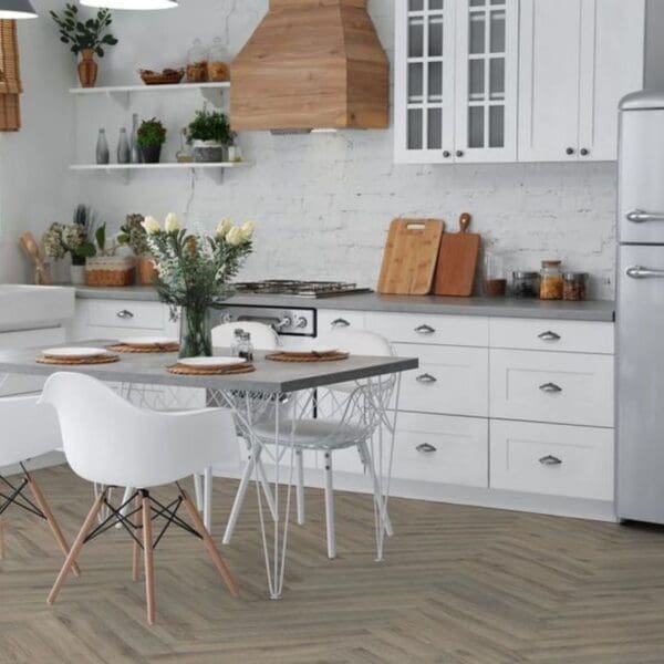 White kitchen with volcanic oak herringbone flooring and dining table