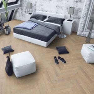 Contemporary bedroom with desert oak herringbone laminate flooring and minimalist decor