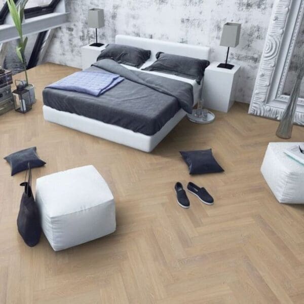 Contemporary bedroom with desert oak herringbone laminate flooring and minimalist decor