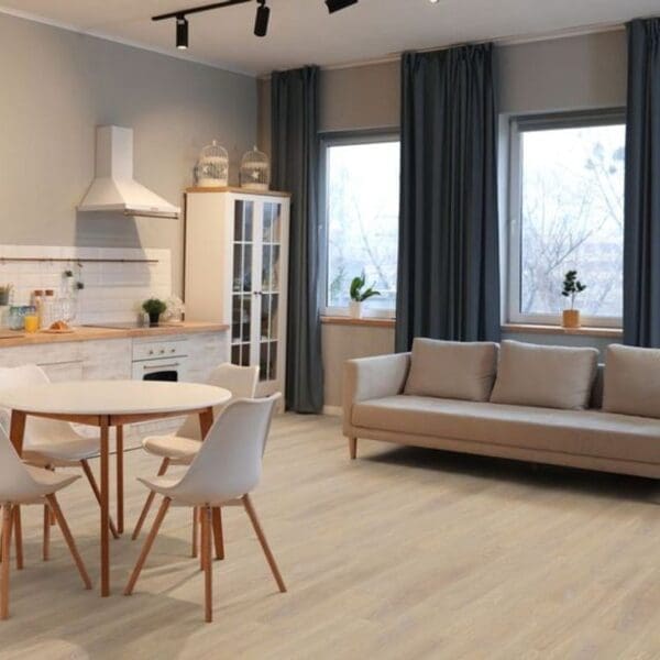 Desert oak laminate flooring in open plan kitchen and living area with beige sofa