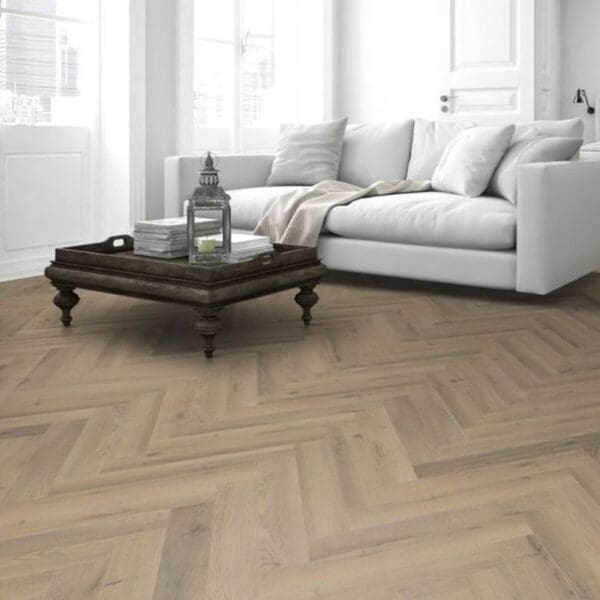 Living room with white sofa and greige oak herringbone laminate flooring