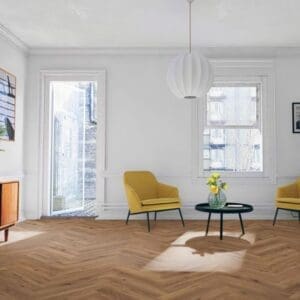Bright living room with yellow chairs and lignum fusion premium robust fumed oak herringbone flooring