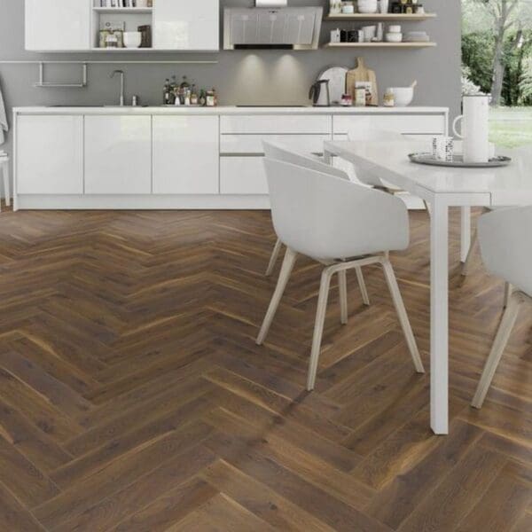 White dining area with coffee oak herringbone laminate flooring and modern chairs