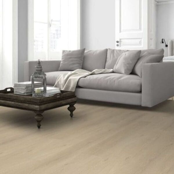 Denver oak laminate flooring installed in modern living room with gray sofa