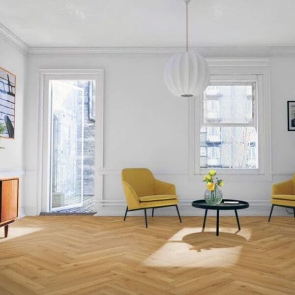 Bright living room with yellow accent chairs and oak herringbone flooring