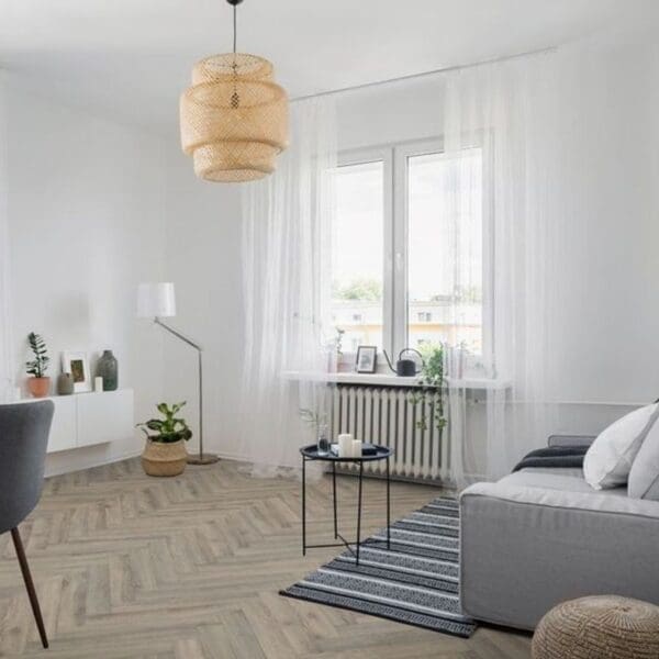 Modern living room with volcanic oak herringbone flooring featuring grey sofa and woven pendant light