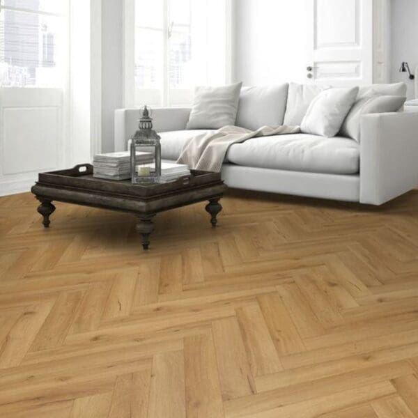 Cozy living space with blue sofa and oak herringbone flooring with ceramic stove