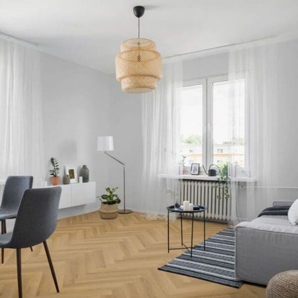Warren oak herringbone laminate flooring in contemporary living room with grey furniture