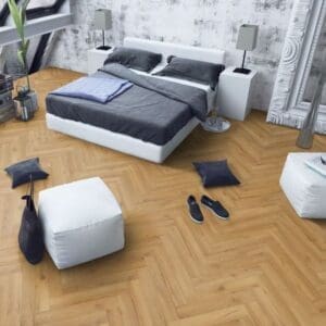 Contemporary bedroom with white bed and oak herringbone flooring with minimalist decor