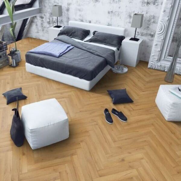 Contemporary bedroom with white bed and oak herringbone flooring with minimalist decor