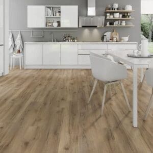 Albany oak laminate flooring in modern kitchen with white cabinets and dining area