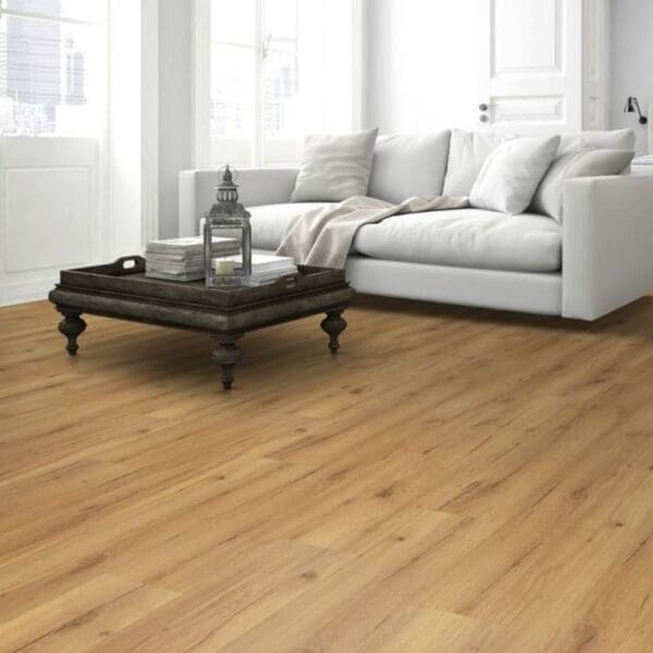 Natural oak laminate flooring in living room with blue sofa and ceramic fireplace
