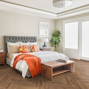 Bedroom with lignum fusion premium robust fumed oak herringbone flooring and grey headboard