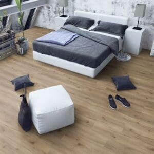 Albany oak laminate flooring in contemporary bedroom with white bed and furniture