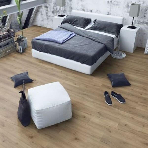 Albany oak laminate flooring in contemporary bedroom with white bed and furniture