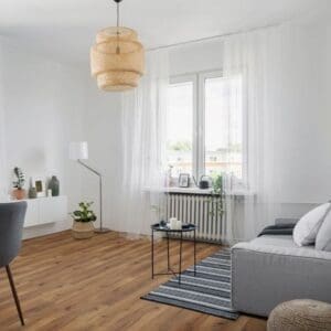 Modern living room with robust fumed oak laminate flooring and contemporary furniture