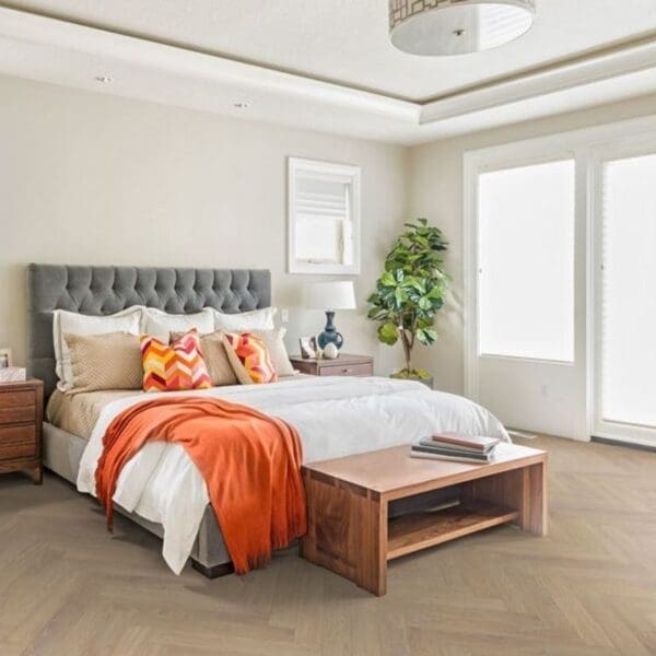 Bedroom with desert oak herringbone laminate flooring and contemporary furniture