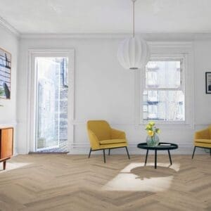 Bright living room with yellow accent chairs and greige oak herringbone laminate flooring
