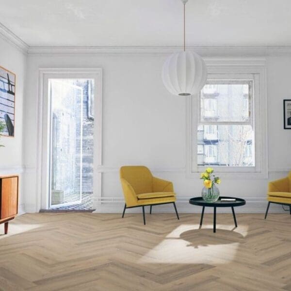 Bright living room with yellow accent chairs and greige oak herringbone laminate flooring