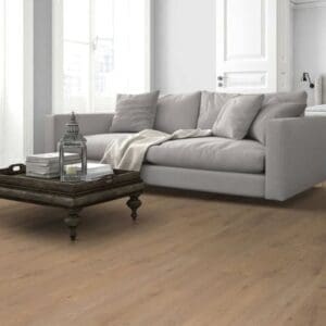 Lignum fusion oregon oak laminate flooring installed in modern living room with grey sofa