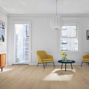 Desert oak laminate flooring in minimalist living room with yellow accent chairs