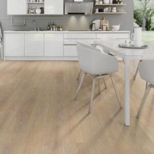 Desert oak laminate flooring in white kitchen dining area with modern chairs