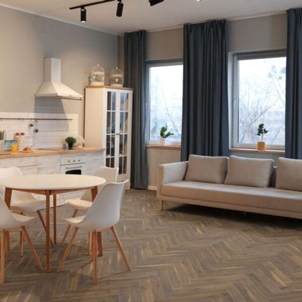 Open plan kitchen and living space with coffee oak herringbone laminate flooring