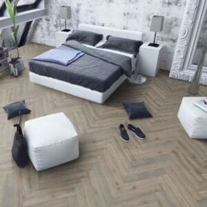 Contemporary bedroom with white furniture and volcanic oak herringbone flooring