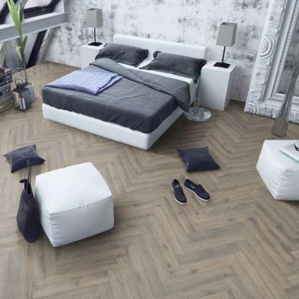 Contemporary bedroom with white furniture and volcanic oak herringbone flooring