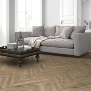 Living room with gray sofa and wooden coffee table on albany oak herringbone flooring