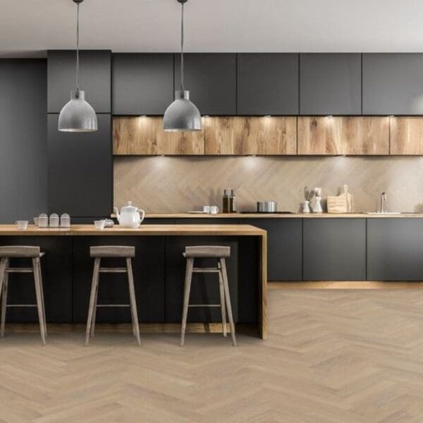 Modern kitchen with black cabinets and desert oak herringbone laminate flooring