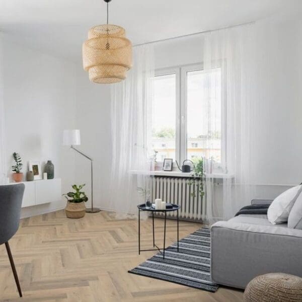 Bright living room with greige oak herringbone laminate flooring and modern furniture