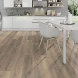 Greige oak laminate flooring in scandinavian style living room with blue sofa and ceramic stove