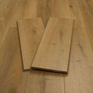 Harvest oak plank laminate flooring with warm honey tones and natural wood grain pattern