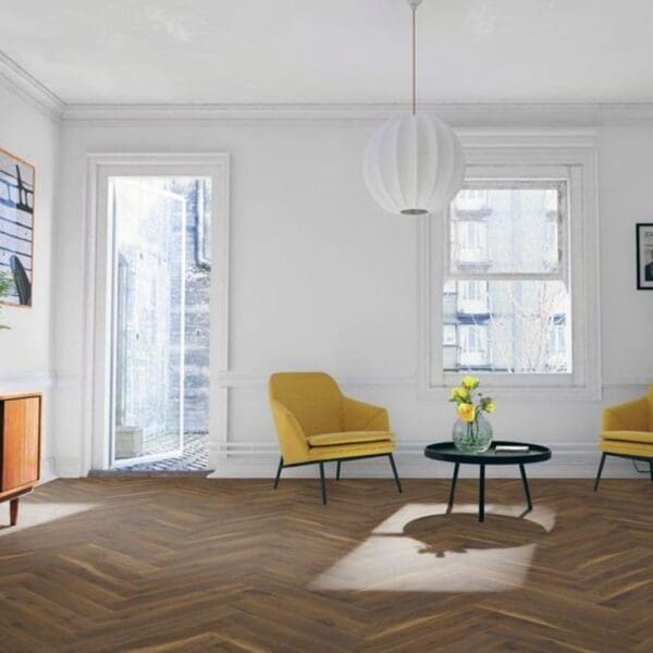 Bright living room with yellow accent chairs and coffee oak herringbone laminate flooring
